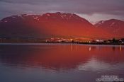 Travel photography:Midnight sun on midsummer night over the fjords at Akureyri, Iceland