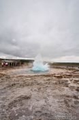 Travel photography:A geysir erupts at the Geysir Centre on the Golden Circle tourist route, Iceland