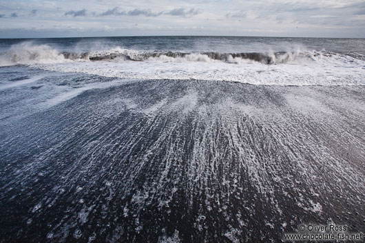 Waves running off the beach at Vik