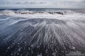 Travel photography:Waves running off the beach at Vik, Iceland