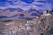 Travel photography:Diskit Gompa (buddhist monastery) with Chosling School in the background, India