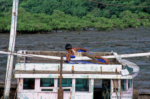 Having a nap on his boat at Elephanta Island near Mumbai