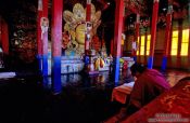 Travel photography:Monk with statue inside the Thiksey Gompa, India