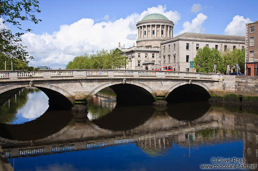 Bridge across the river Liffey in Dublin with Four Courts