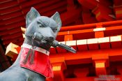 Travel photography:Fox with key sculpture at Kyoto`s Inari shrine, Japan