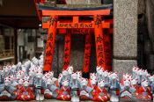 Travel photography:Small figurines of foxes at Kyoto´s Inari shrine, Japan