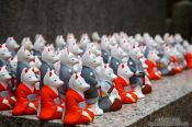 Travel photography:Small figurines of foxes at Kyoto´s Inari shrine, Japan