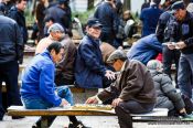 Travel photography:Old men playing Go in a park near the Jongmyo Royal Shrine in Seoul, South Korea