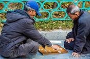 Travel photography:Old men playing Go in a park near the Jongmyo Royal Shrine in Seoul, South Korea