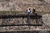 Travel photography:People sitting at the base of the sub pyramid at the Teotihuacan archeological site, Mexico