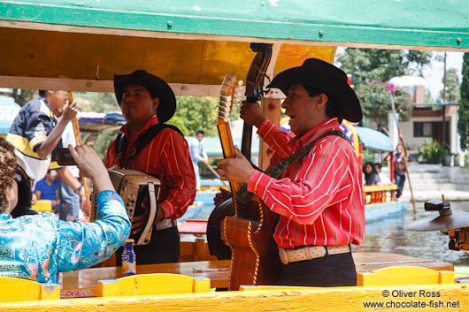 Mariachi provide entertainment on some of the colourful trajineras (rafts) on Lake Xochimilco