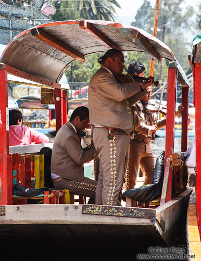 Mariachi provide entertainment on some of the colourful trajineras (rafts) on Lake Xochimilco