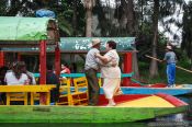 Travel photography:Dancing to the tune of the Mariachi on one of the colourful trajineras (rafts) on Lake Xochimilco, Mexico