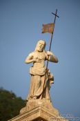 Travel photography:Figure atop a baroque palace in Perast dating from the Venetian period, Montenegro