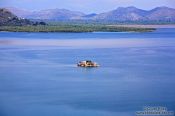 Travel photography:View of Skadarsko jezero (Scutari lake) with isolated monastery, Montenegro