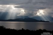 Travel photography:Rays of light break through the clouds in Fiordland National Park, New Zealand