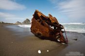 Travel photography:Ship wrek on a beach near Honeycomb Rock, New Zealand