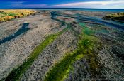 Travel photography:Stream entering the sea in Palliser Bay, New Zealand