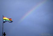 Travel photography:The rainbow flag over Cusco with real rainbow, Peru