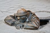Travel photography:Bronze statue of Cumil in Bratislava, Slovakia
