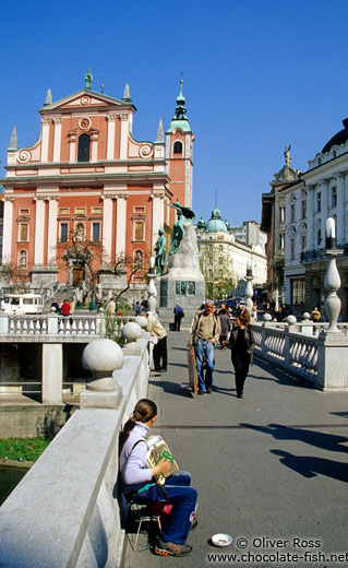 One of the bridges of Tromostovje (triple bridges) with the Franciscan church and Prešeren Square in Ljubljana