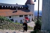 Travel photography:Monk ascending stairs in Bled castle, Slovenia