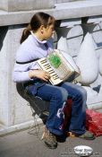 Travel photography:Girl with accordion busking in Ljubljana, Slovenia