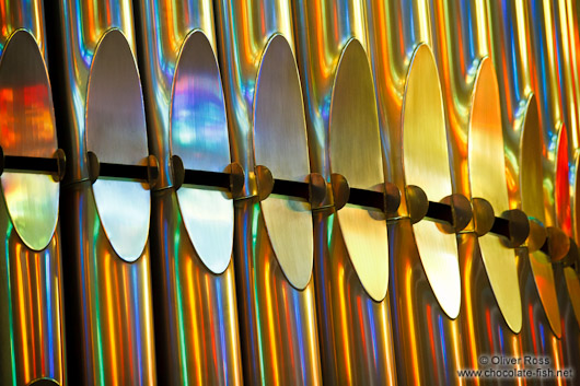 Colourful light from the stained glass windows is reflected off the organ pipes in the Sagrada Familia