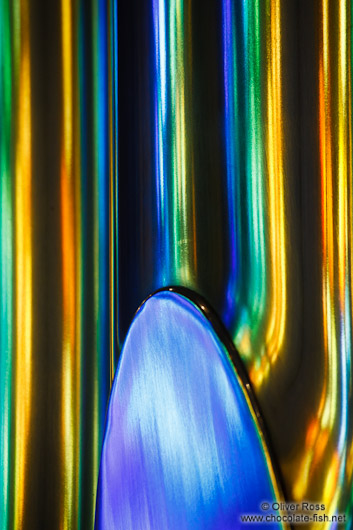 Colourful light from the stained glass windows is reflected off the organ pipes in the Sagrada Familia