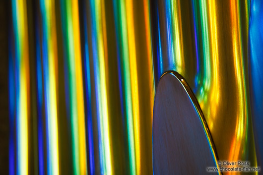 Colourful light from the stained glass windows is reflected off the organ pipes in the Sagrada Familia