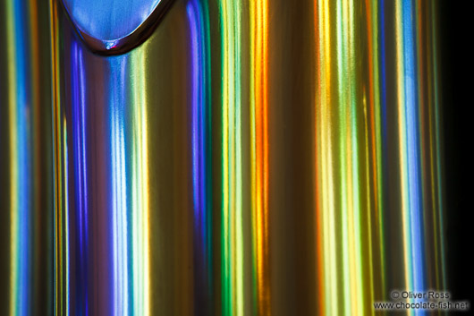 Colourful light from the stained glass windows is reflected off the organ pipes in the Sagrada Familia