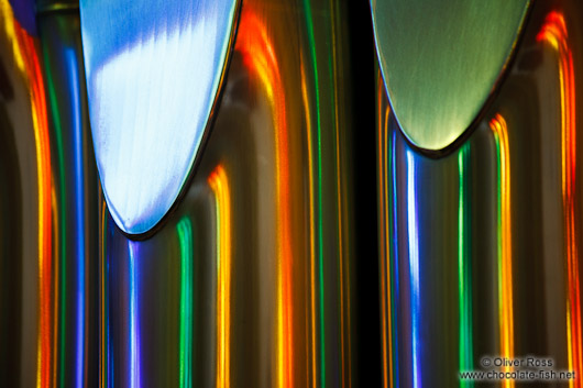 Colourful light from the stained glass windows is reflected off the organ pipes in the Sagrada Familia