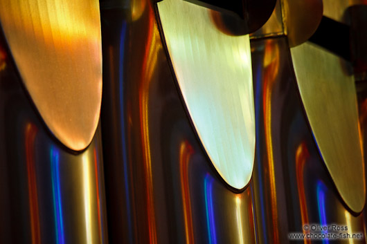 Colourful light from the stained glass windows is reflected off the organ pipes in the Sagrada Familia