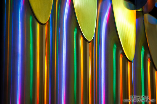 Colourful light from the stained glass windows is reflected off the organ pipes in the Sagrada Familia