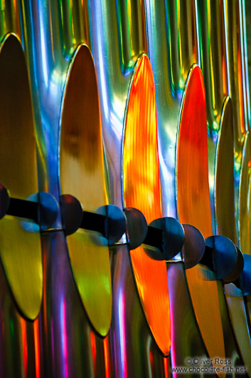 Colourful light from the stained glass windows is reflected off the organ pipes in the Sagrada Familia