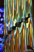 Travel photography:Colourful light from the stained glass windows is reflected off the organ pipes in the Sagrada Familia, Spain