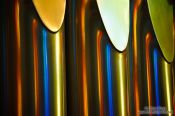 Travel photography:Colourful light from the stained glass windows is reflected off the organ pipes in the Sagrada Familia, Spain