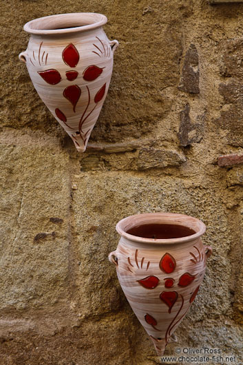 Flower pots decorate a house in Pals