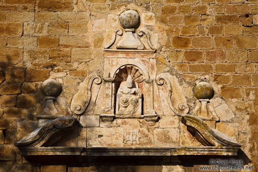 Facade detail above the entrance to the church in Pals
