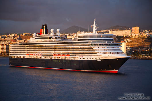 The Queen Mary cruise ship enters Las Palmas harbour at sunrise