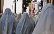 Travel photography:White head scarfs worn by women during the Good Friday procession in Las Palmas, Spain