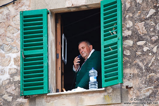 Man shaving at open window in Valldemossa village