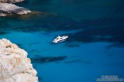 Travel photography:Anchored boat in a bay near Cap Formentor, Spain