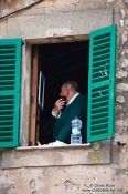 Travel photography:Man shaving at open window in Valldemossa village, Spain
