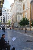 Travel photography:Busker outside the Palau del Marqués de Dosaigües in Valencia, Spain