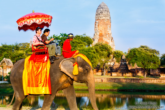 Tourists riding on an elephant through Ayutthaya