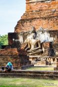 Travel photography:Man with Buddha at the Sukhothai temple complex, Thailand