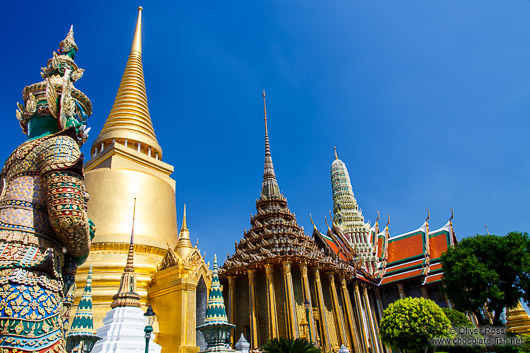 Stone guardian and golden stupa at Wat Phra Kaew, the Bangkok Royal Palace