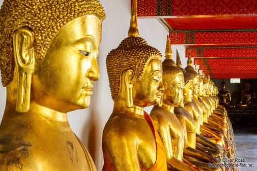 Row of golden Buddhas at Wat Pho temple in Bangkok