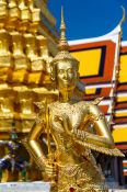 Travel photography:Golden Kinnara sculpture at Wat Phra Kaew, the Bangkok Royal Palace, Thailand